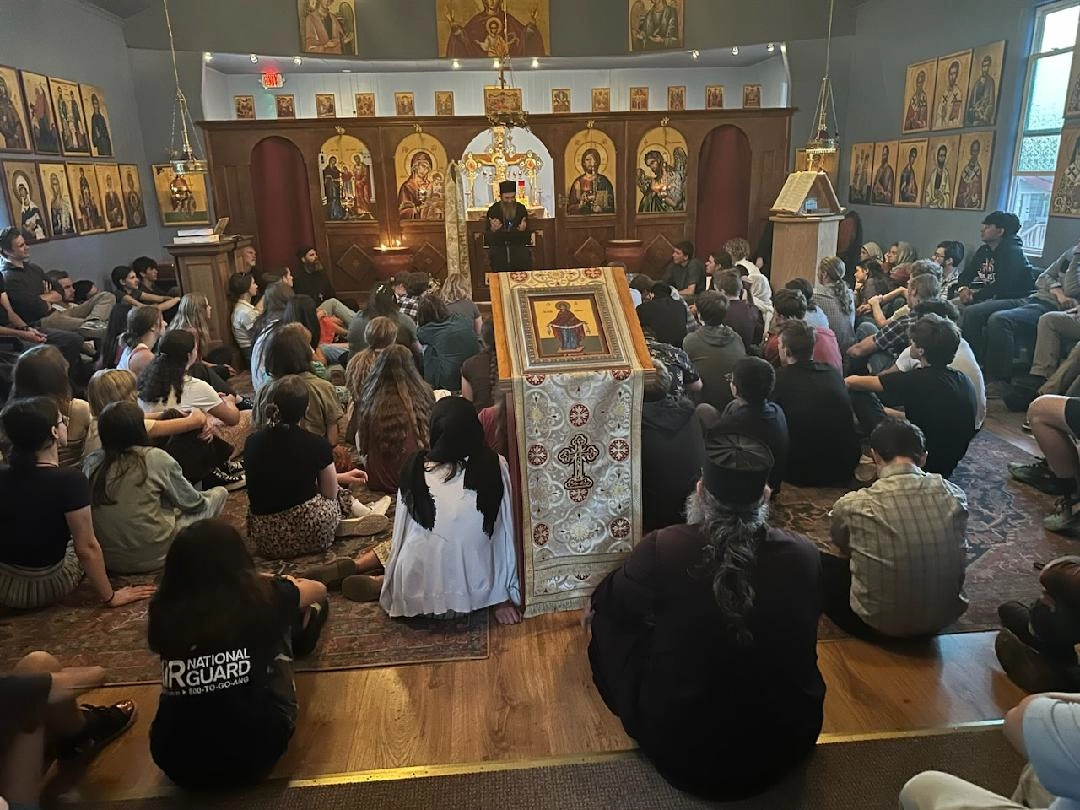 Youth seated in a church listening to a speaker